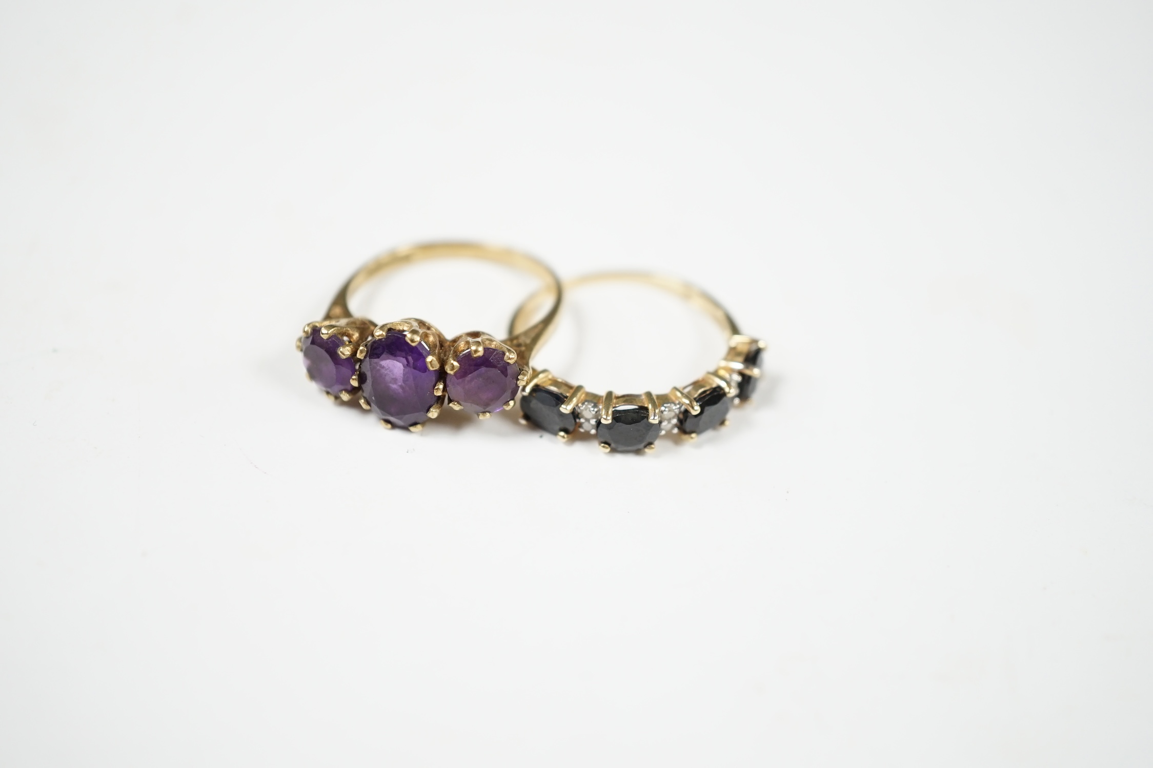 Two modern 9ct gold and gem set rings including three stone amethyst, size O and sapphire and diamond chip half hoop, gross weight 4.9 grams. Condition - fair